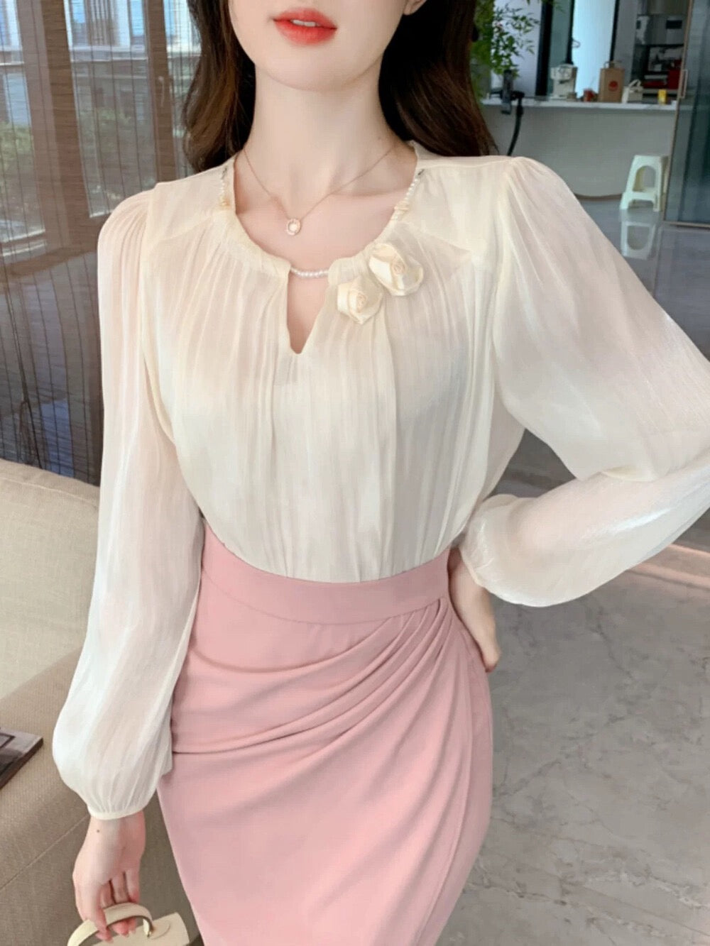 Gentle and shiny blouse with flower decoration