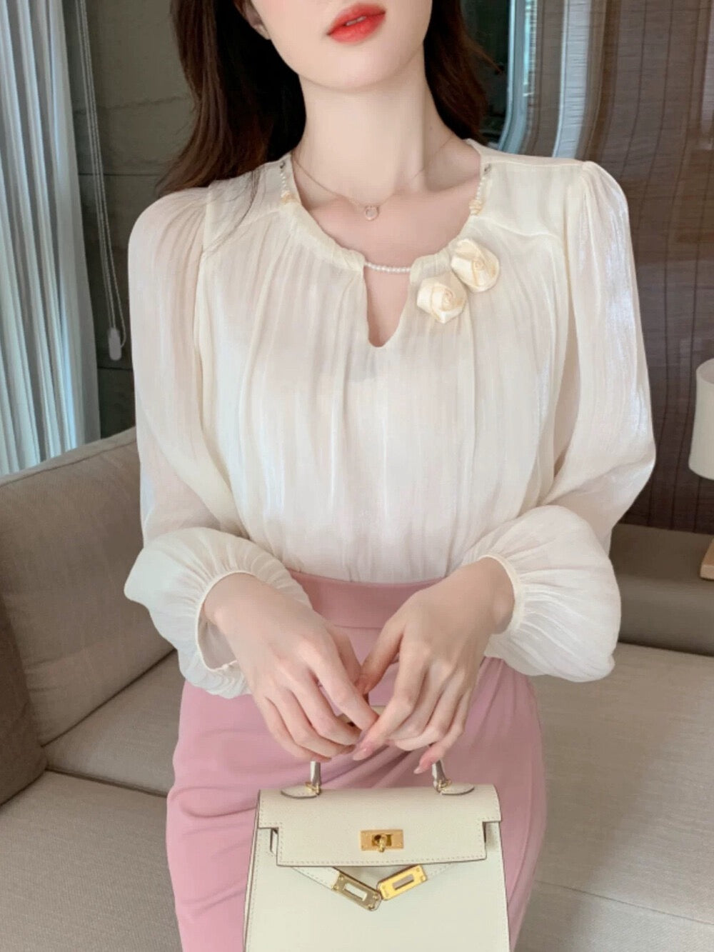 Gentle and shiny blouse with flower decoration
