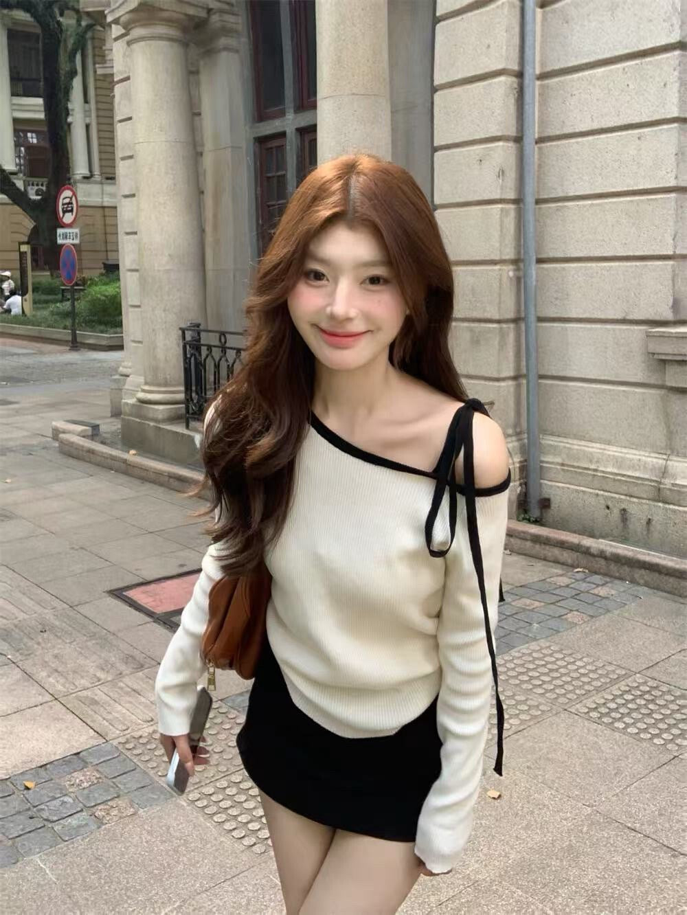 White sweater with contrasting black and white lace-up shoulder straps