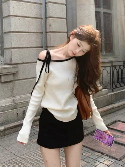 White sweater with contrasting black and white lace-up shoulder straps