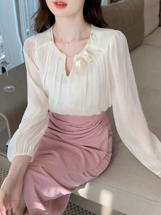 Gentle and shiny blouse with flower decoration