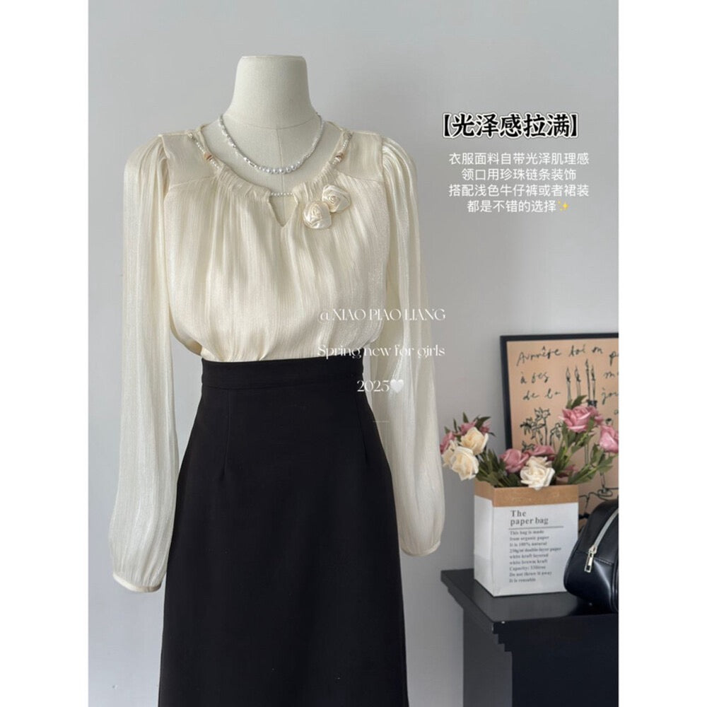 Gentle and shiny blouse with flower decoration